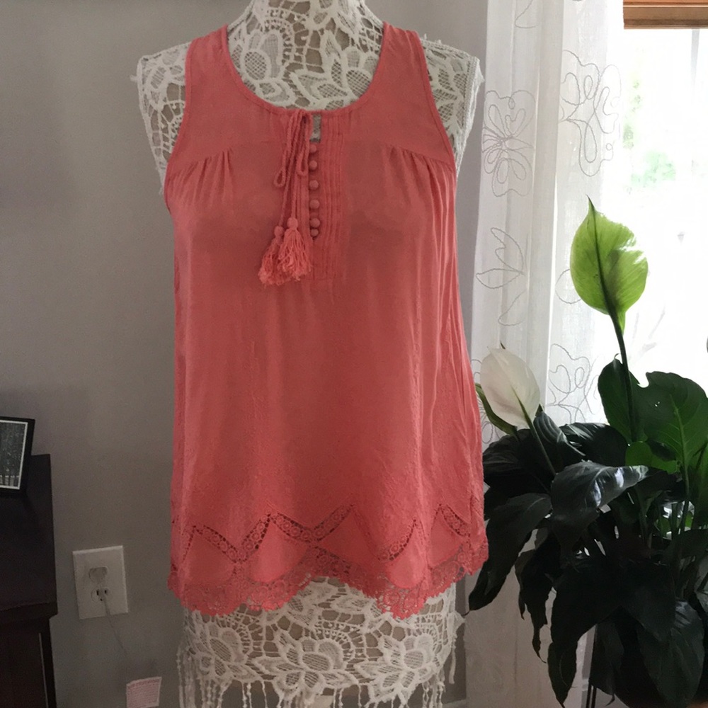 Francesca’s coral sleeveless shirt.